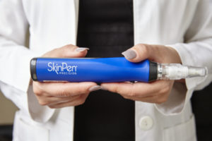 doctor holding SkinPen microneedling device