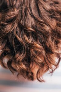 hair growth page photo of a woman's long curly hair